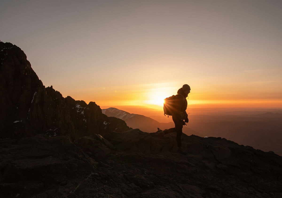Hiker on the rocks at sunset in the High Atlas
