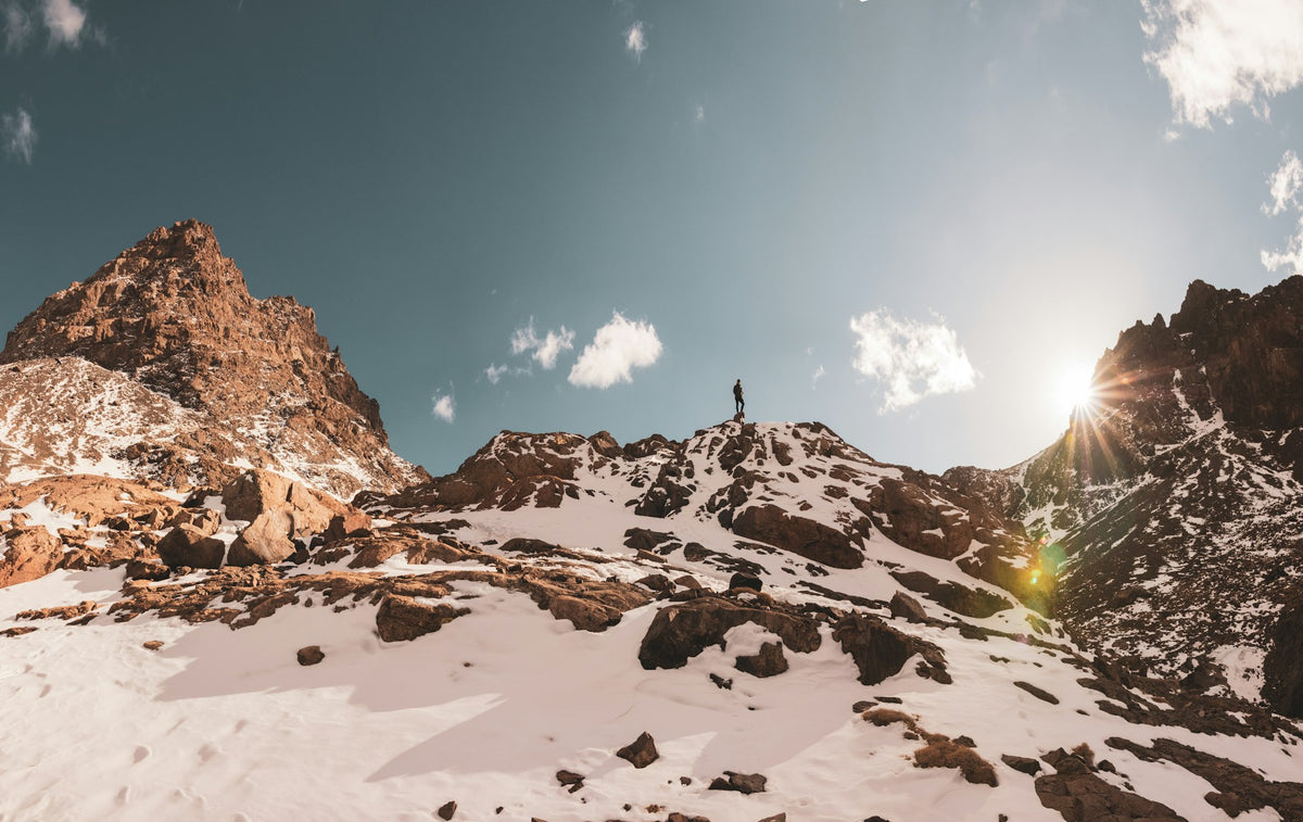 Person standing on a snow-covered summit